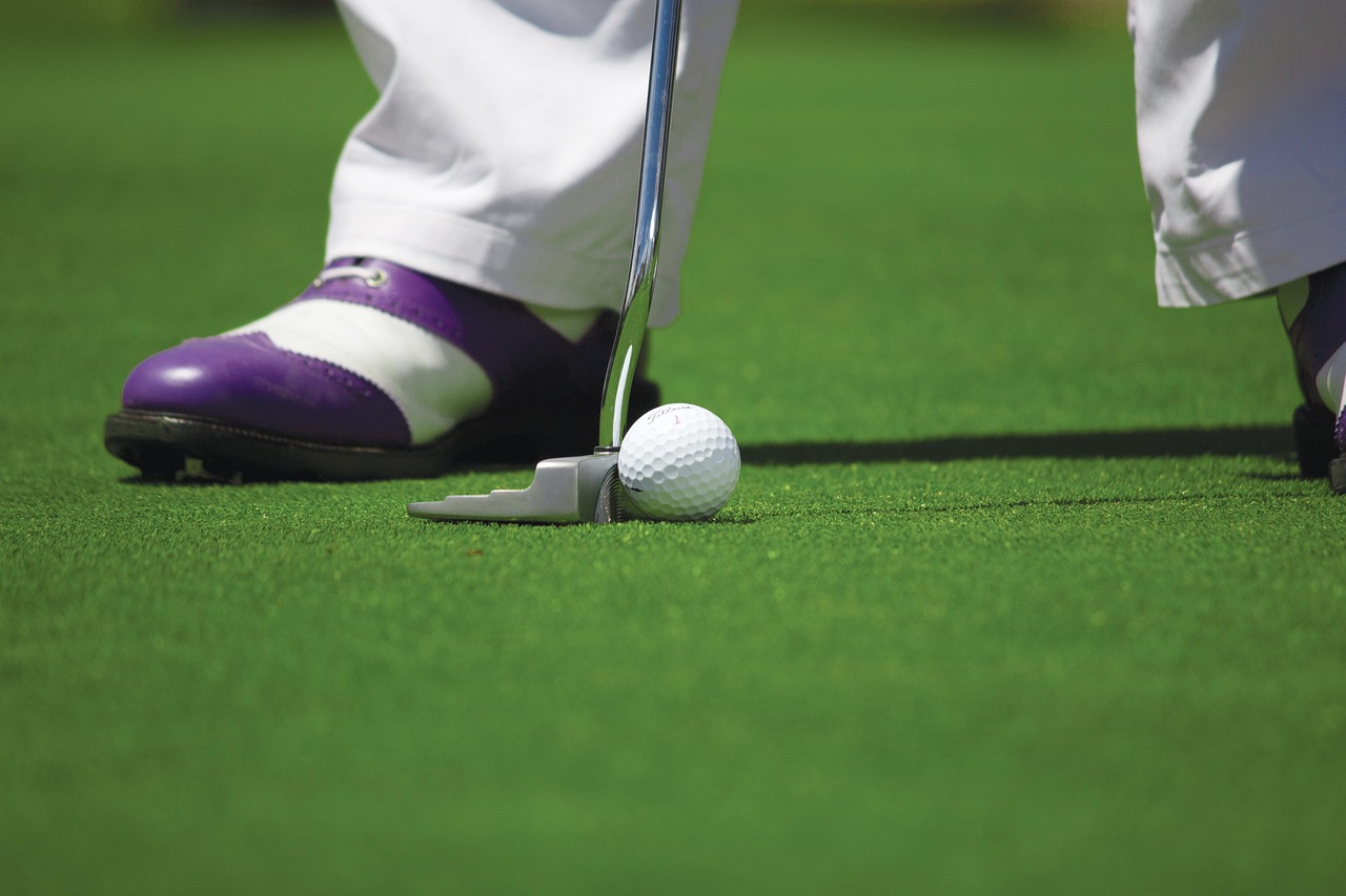 Golfer putting golf ball