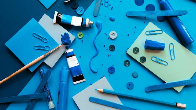 Blue papers, buttons, markers, paint, beads