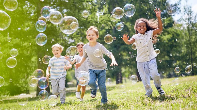 Children running with bubbles